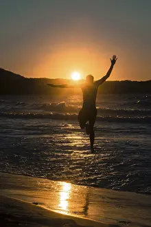 Prints of Young man, silhouette, jumping on the beach at sunset, sunset by the sea, Haute-Corse, Corsica, France Corse Prints: Young Man Jumping at Sunset Print, Haute-Corse, Corsica