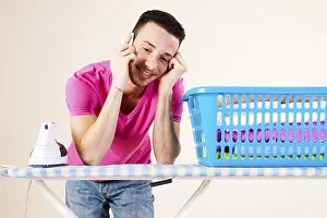 Prints of Young man talking on the telephone while leaning on an ironing board, Mannheim, Baden-Wurttemberg, Germany Young man talking on the telephone while leaning on an ironing board, Mannheim Mannheim Prints: Young Man on Telephone Print, Mannheim, Germany