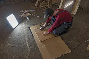 German Handicrafts Prints: Young man working with an angle grinder in his workshop