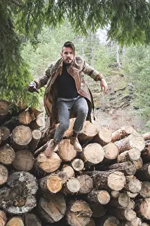 Forest Landscape Photography Prints: Young men on logs in the forest