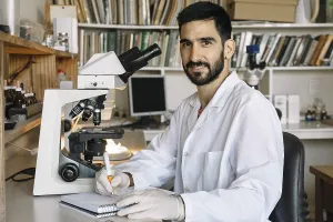 Medical Diagnosis Process Prints: Young scientist in front of microscope