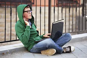 University Campus Portraits Prints: Young student using laptop
