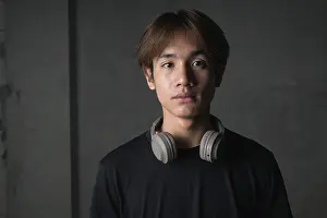 Prints of Young Thai Asian man wearing a black t-shirt, posing in a minimalist brutalist-style construction area with gray concrete walls concept of modern lifestyle, urban fashion and architecture Brutalist Architecture Prints: Young Thai Man in Brutalist Construction Area Print