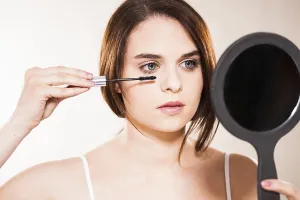 Prints of Young woman applying make-up, Mannheim, Baden-Wurttemberg, Germany Young woman applying make-up, Mannheim, Baden-Wrttemberg, Germany Mannheim Prints: Young Woman Applying Make-up Print, Mannheim, Germany