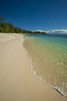 African Island Getaway Prints: Water surging gently onto a pristine